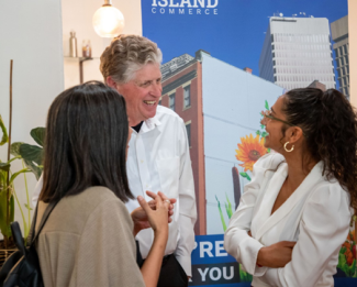 Governor McKee having a conversation with 2 people