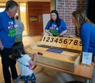 Governor with students playing with numbered blocks
