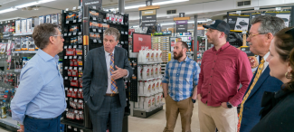 Governor speaking in a hardware store