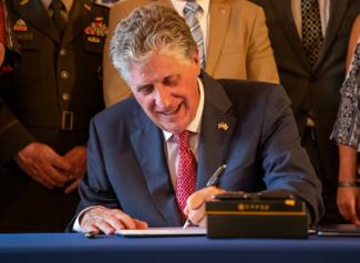 Governor McKee signing a Bill