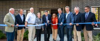 Governor McKee and others doing a ribbon cutting