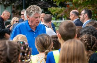 Governor McKee interacting with a crowd of students
