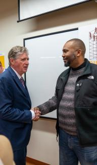 Governor McKee shaking hands with an individual